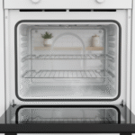 A highly detailed, realistic professional lifestyle photograph of a sparkling clean modern oven interior, with pristine white enamel walls, spotless racks, and a gleaming glass door reflecting soft kitchen light, captured in high resolution 8K, photorealistic style, natural daylight illumination, subtle steam wisps from a fresh clean, professional product photography with sharp focus, impeccable cleanliness emphasizing simple cleaning methods, cozy home kitchen setting, 2025 trends in ultra-HD quality.